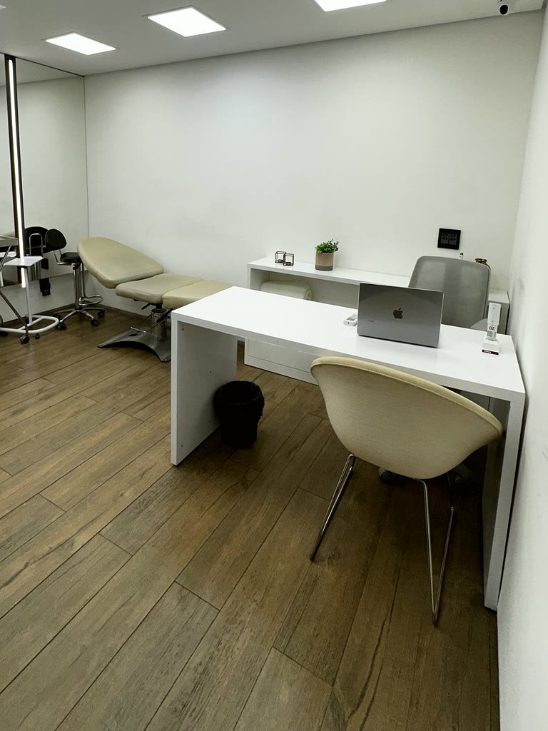 Sala de atendimento reservada, com mesa e maca